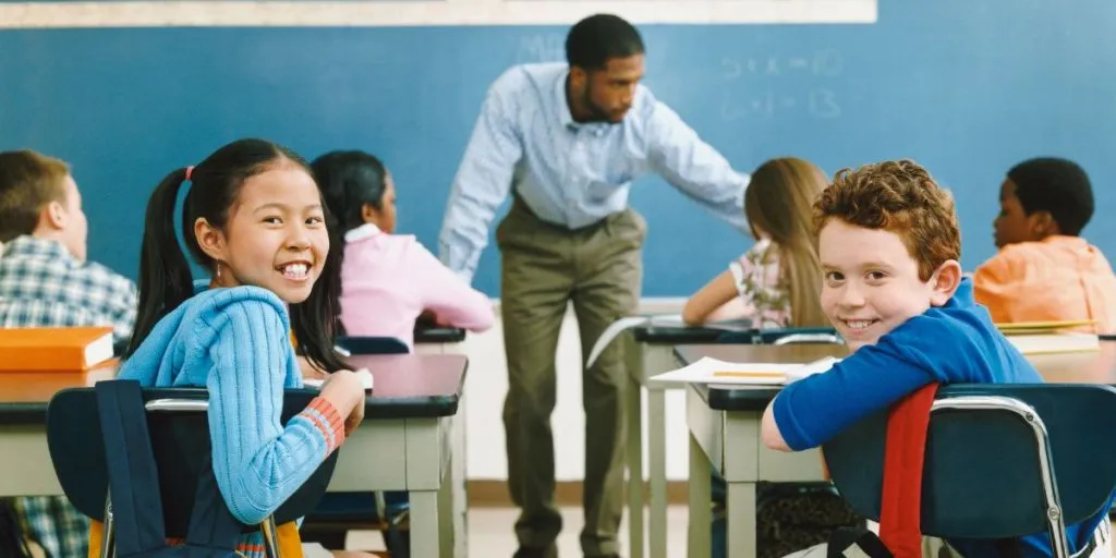 Image of diverse happy students back to school in the classroom.